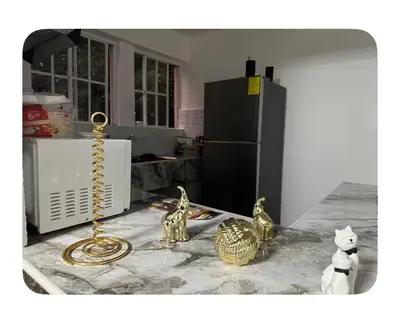 a kitchen with gold items on a counter with a refrigerator at Apartamento estadio CUSCATLAN in San Salvador