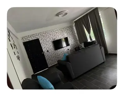 a living room with a couch and a fireplace at Apartamento estadio CUSCATLAN in San Salvador