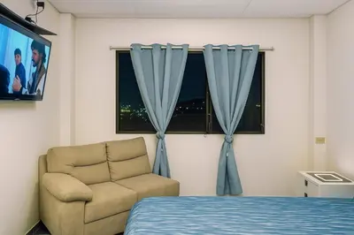 a bedroom with a bed and a chair and a window at Suite Linda Vista Descanso y Naturaleza in San Marcos