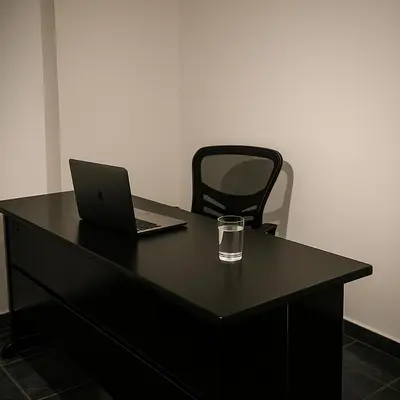 a black desk with a laptop and a glass on it at Suite Linda Vista Descanso y Naturaleza in San Marcos