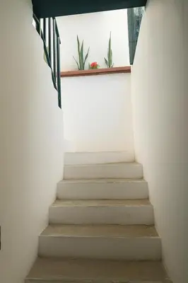 a staircase in a house with a window at Suite Linda Vista Descanso y Naturaleza in San Marcos