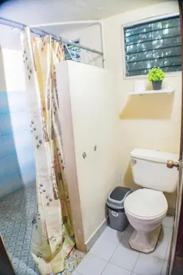 a bathroom with a toilet and a shower at Rancho Mayayi Beach house in San Miguel