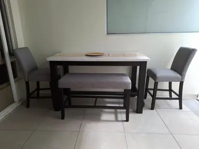 a table with two chairs and a table with a plate on it at The Diamond Hotel San Benito in San Salvador