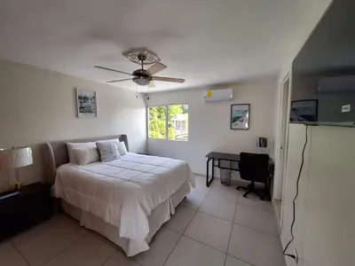 a bedroom with a bed and a ceiling fan at The Diamond Hotel San Benito in San Salvador
