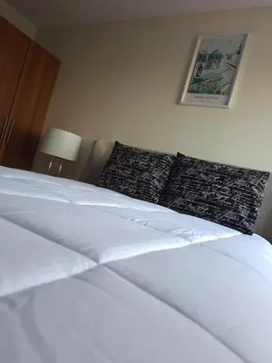 a bedroom with a white bed with pillows at The Diamond Hotel San Benito in San Salvador