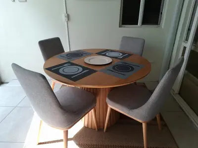 a wooden table with four chairs around it at The Diamond Hotel San Benito in San Salvador