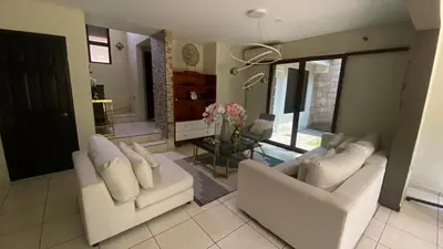 a living room with two white couches and a table at Casa Miramar, relaxation and work