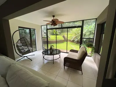 a living room with a couch and a ceiling fan at Casa Miramar, relaxation and work