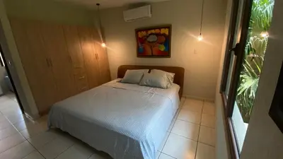 a bedroom with a bed and a painting on the wall at Casa Miramar, relaxation and work