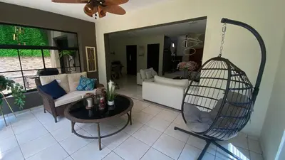 a living room with a bird cage and a couch at Casa Miramar, relaxation and work