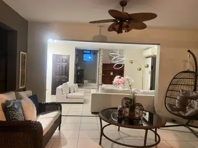 a living room with a couch and a ceiling fan at Casa Miramar, relaxation and work