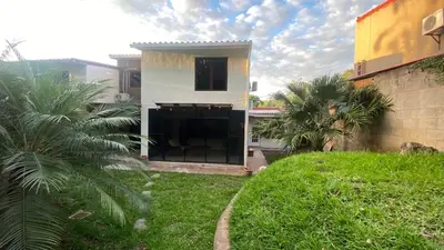 a house with a lawn in front of a building at Casa Miramar, relaxation and work