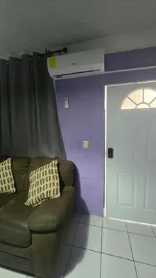 a living room with a couch and a door at the best private apartmet in santa ana for your trip with excelente location in Santa Ana
