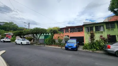 a blue car parked on the side of a street at Casa en Altos del Cerro in Soyapango