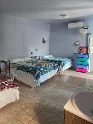 a bedroom with two beds and a sink in it at Surf House