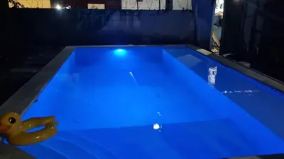 a blue pool with a rubber duck toy in it at Surf House