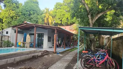 a house with bikes parked next to a pool at Surf House