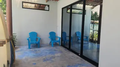 a group of blue chairs sitting in a room at Surf House