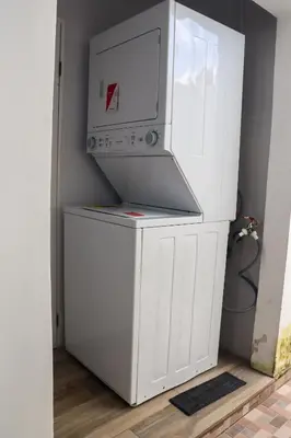 a white refrigerator freezer sitting in a room at Casa Veraneras in Santa Ana