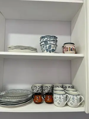 a shelf filled with cups and plates and bowls at Casa Veraneras in Santa Ana