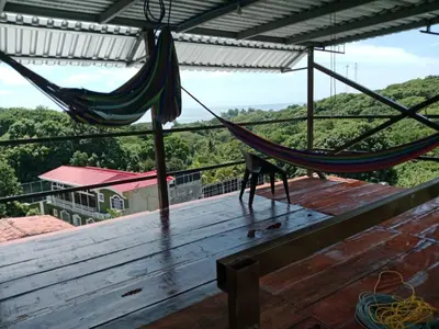 a hammock on the roof of a house with a view at K-Chimbón Zonte playa! Best place view! in El Zonte