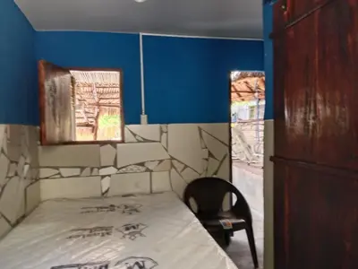a bedroom with a bed and a chair and blue walls at K-Chimbón Zonte playa! Best place view! in El Zonte