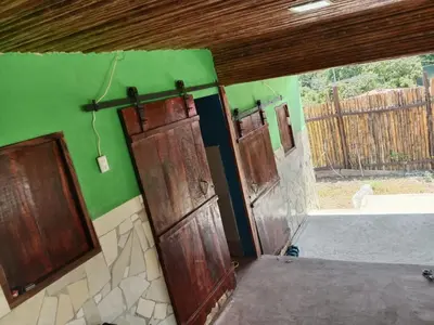 an empty room with two doors and a window at K-Chimbón Zonte playa! Best place view! in El Zonte
