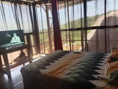 a bedroom with a bed and a tv on a table at K-Chimbón Zonte playa! Best place view! in El Zonte