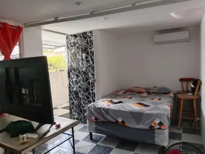 a bedroom with a bed and a tv in a room at Habitaciones Clásica en lo mejor de SS city in San Salvador