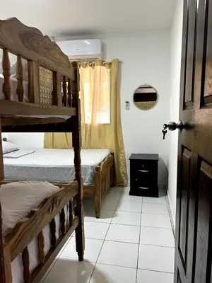 a bedroom with two bunk beds and a window at BuenaMar Malibu Beach in Sonsonate