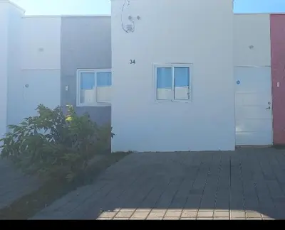 a white door of a building next to a porch at Casa Ecoterra in Comecayo