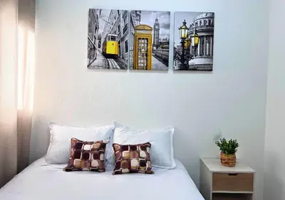 a bedroom with a bed with a yellow phone booth and buildings at Colibri de Montaña in Ahuachapán