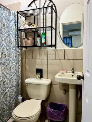 a bathroom with a toilet and a sink and a mirror at Apartment near to the best San Salvador areas in San Salvador