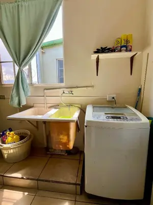 a small kitchen with a sink and a washing machine at Apartment near to the best San Salvador areas in San Salvador