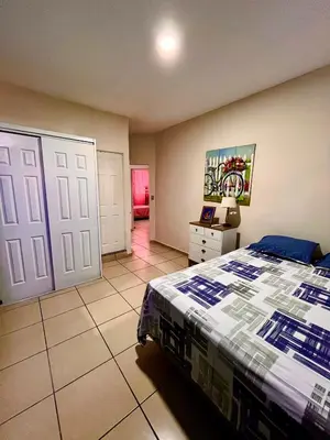 a bedroom with a bed and a room with a door at Apartment near to the best San Salvador areas in San Salvador