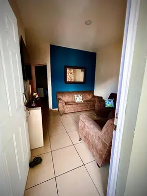 a living room with a couch and blue walls at Apartment near to the best San Salvador areas in San Salvador