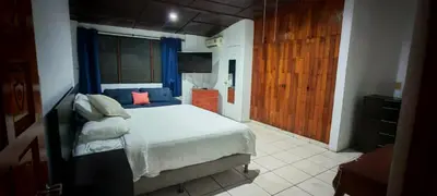 a bedroom with a bed and a television in it at Habitación Lomas de San Francisco in San Salvador