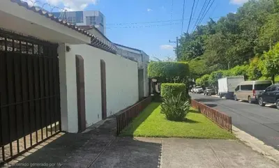 a house with a fence and a small bush on the sidewalk at Habitación Lomas de San Francisco in San Salvador