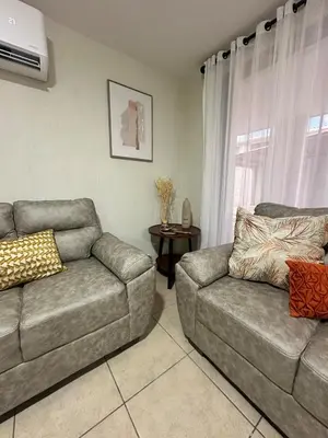 a living room with a couch and a chair at Casa Bella Vista in Apopa