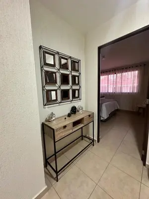 a room with a mirror and a table and a bed at Casa Bella Vista in Apopa