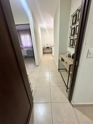 a hallway with a room with a sink and a table at Casa Bella Vista in Apopa