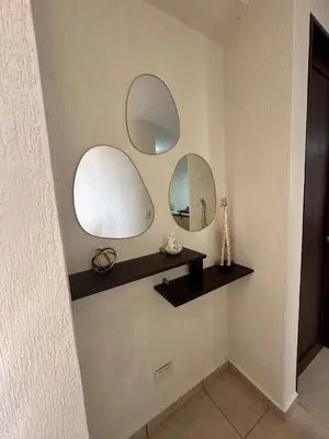 a bathroom with three mirrors on a wall at Casa Bella Vista in Apopa