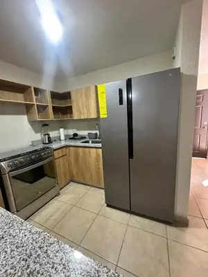 a kitchen with a stainless steel refrigerator in it at Casa Bella Vista in Apopa