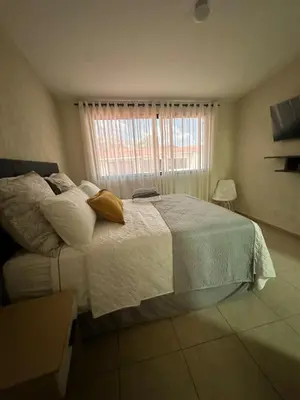 a bedroom with a large bed and a window at Casa Bella Vista in Apopa