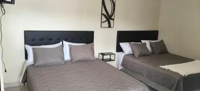 a bedroom with two beds in a room at Hotel Sweet Dreams in La Unión
