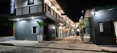 an empty alley with two plants in white vases at Hotel Sweet Dreams in La Unión