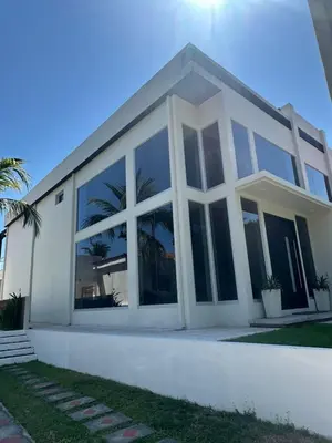 a white house with large windows at Casa Cristal in San Luis La Herradura