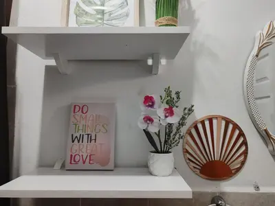 a white shelf with a vase and flowers on it at Sunzal Loft, ISA Ecovilla Surfing in El Sunzal