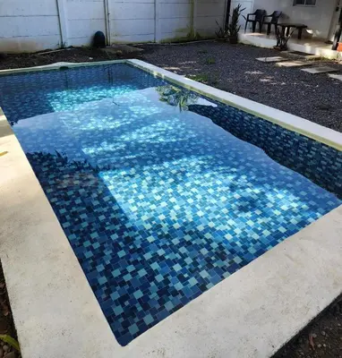 a swimming pool with blue tiles on it at Sunzal Loft, ISA Ecovilla Surfing in El Sunzal