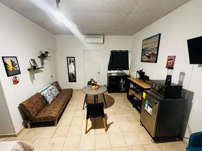 a living room with a couch and a table at Sunzal Loft, ISA Ecovilla Surfing in El Sunzal